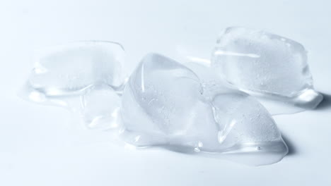 Cold-Ice-Cubes-Melting-Time-lapse-In-White-Background