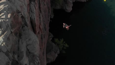 Three-flips-and-a-twist,-young-cliff-jumper-in-slo-mo-from-high-cliff