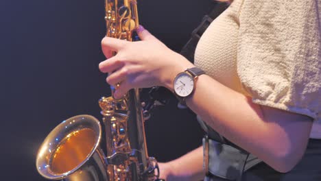 Close-Up-of-Female-Hands-and-Fingers-on-Golden-Saxophone-Instrument-Playing-Solo