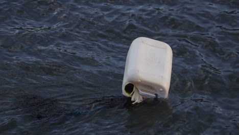 A-floating-white-container-in-a-river