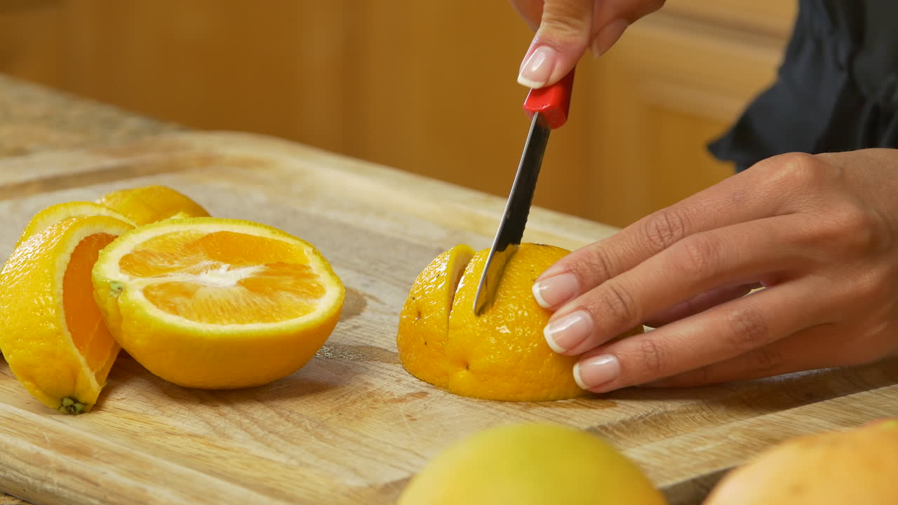 Premium stock video - Cutting an orange