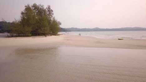 A-closing-in-aerial-shot-of-a-couple-jogging-together-along-the-sandy-beach---Thailand