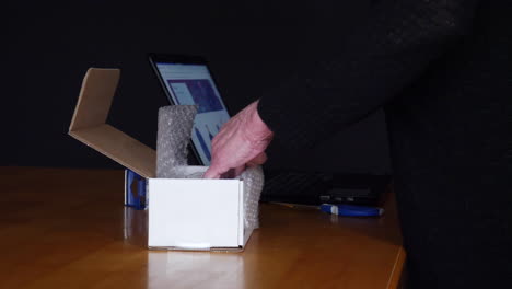 Packing-and-shipping-an-item-sold-online-in-a-cardboard-box-with-bubble-wrap-to-a-customer-through-an-auction-ecommerce-website
