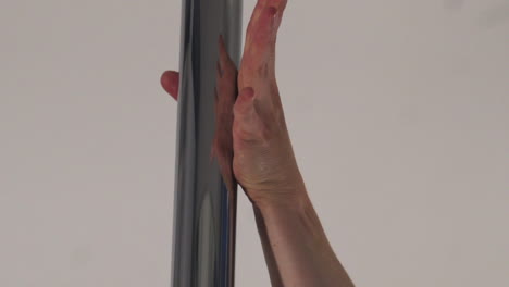 Close-up-of-a-female-hand-grabbing-onto-a-Poledance-pole