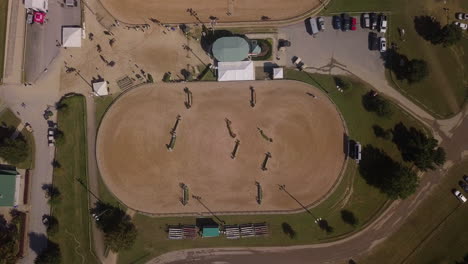 Top-down-view-of-the-warm-up-ring-at-an-equestrian-show-jumping-competition