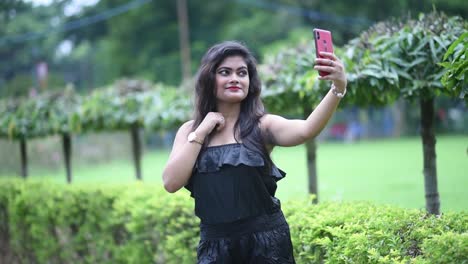 A-beautiful-and-hot-Asian-girl-wearing-short-Black-dress-is-taking-her-selfies-with-her-mobile-phone,-accidentally-about-to-drop-the-phone-,-closeup-slow-motion