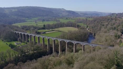 People-walk-across-the-beautiful-Narrow-Boat-canal-route-called-the-Pontcysyllte-Aqueduct-famously-designed-by-Thomas-Telford,-located-in-the-beautiful-Welsh-countryside,-A-huge-bridge-viaduct