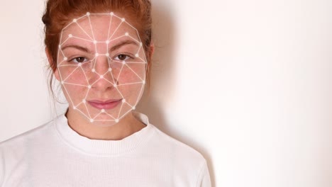 Close-up-of-a-young-woman-with-red-hair,-with-a-white-shirt-on-a-white-background,-with-facial-recognition-high-tech-animation-with-tracking-points-and-a-glow-effect-on-her-face