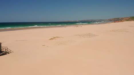 Aerial:-The-large-dunes-and-beach-of-the-surf-spot-Bordeira,-Portugal