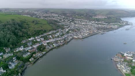 Aerial-tracking-forward-towards-the-historic-town-of-Dartmouth,-UK
