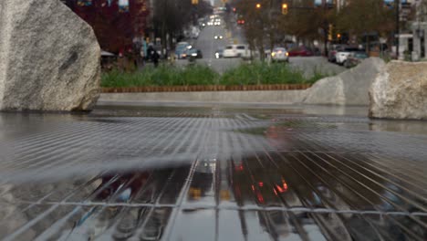 Timelapse-of-traffic-reflecting-in-flowing-waves-of-water