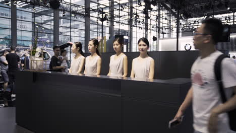 Female-BMW-Representatives-stand-behind-the-Information-Desk-at-2019-International-Auto-Show-in-Shenzhen,-China