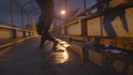African-American-man-dancing-on-a-bridge-during-a-rainy-night