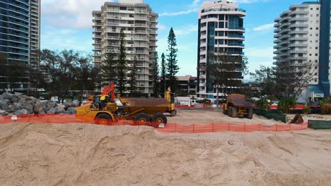 Heavy-construction-equipment-being-used-to-repair-beach-sand-dunes-damaged-by-recent-swell-from-a-tropical-cyclone
