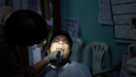 A-Dentist-Treating-A-Patient-with-Oral-Prophylaxis-Process