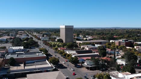 A-push-in-drone-shot-of-Bulawayo,-Zimbabwe's-Revenue-Hall-under-sunny-conditions