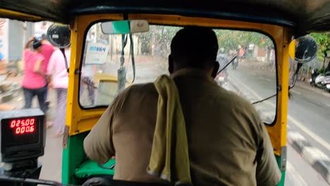 Footage-of-an-auto-rickshaw-shot-from-the-back-seat-running-through-traffic