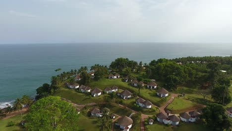 Aerial-shot-of-resort-and-thatched-roofs-of-villas-in-Mermaids-Bay-in-San-Pedro-Southwest-Ivory-Coast-Africa