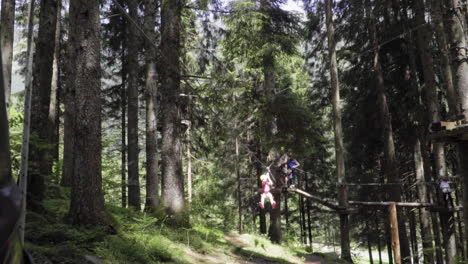 Little-girl-with-red-hair-on-a-pulley-in-adventure-park-in-the-Italian-Alps,-slow-motion