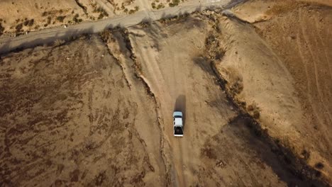 A-white-pickup-truck-traveling-through-the-Desert