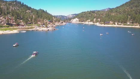 Aerial-drone-footage-flying-over-Big-Bear-lake-passing-boats-below