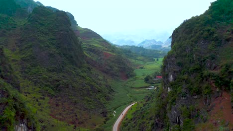 A-road-in-a-deep-valley-that-cuts-through-a-mountain-in-northern-Vietnam