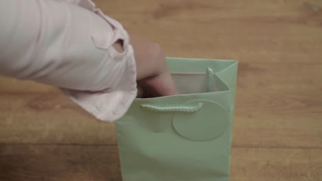 Woman-looking-inside-a-gift-bag