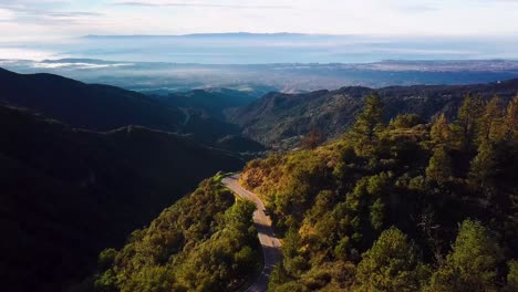 Cyclist-on-curvy-Mountain-Road-above-Santa-Barbara-at-Dawn,-Drone-Chase