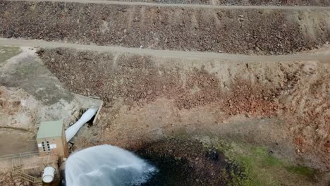Drone-footage-moving-upwards-of-the-dam-wall,-water-outlet-and-water-tower-at-Lake-Nillahcootie,-Victoria,-Australia