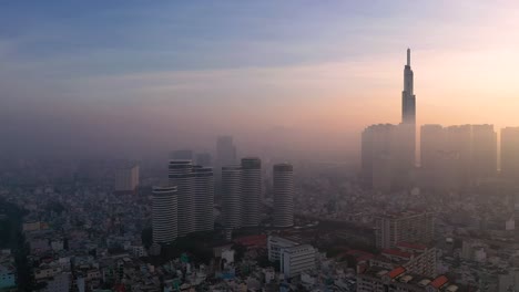 Smoggy,-beautiful-Sunrise-over-Ho-Chi-Minh-City-featuring-City-Garden-and-Landmark-from-drone