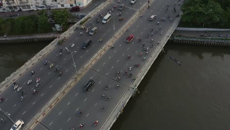 High-static-aerial-view-of-evening-traffic-over-Dien-Bien-Phu-Bridge,-Binh-Thanh-district,-Ho-Chi-Minh-City,-Vietnam-which-crosses-the-Hoang-Sa-canal