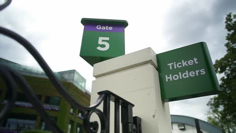 Wimbledon-2019:-entrance-to-the-championship-tournament-from-gate-5-in-front-of-the-centre-court,-with-another-sign-below-that-says-ticket-holders