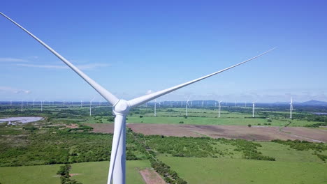 aerial-view-of-wind-turbine,-trees,-on-sunny-day