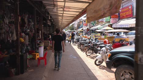 Male-Tourist-Walking-on-the-Sidewalk-Outside-Old-Market