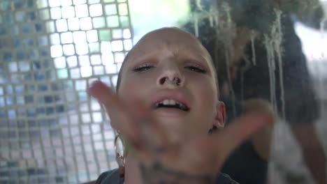 Young-woman-with-tattoos-and-a-shaved,-bald-head-is-dancing-with-passion-and-energy-in-a-sensual-and-powerful-way