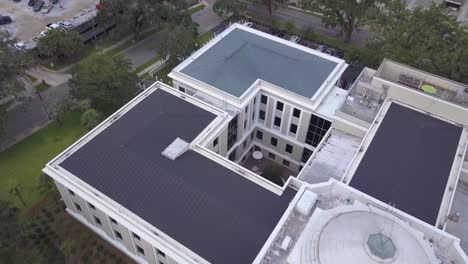 Flying-over-Florida-Supreme-Court-Building-and-flag-pole,-Tallahassee,-eagle-eye