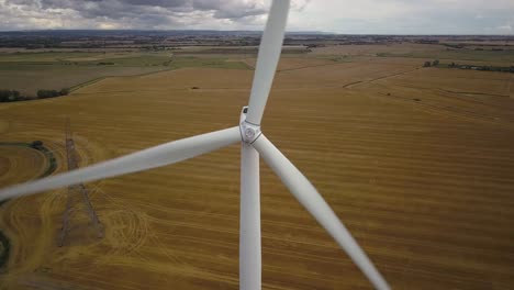 Aerial-closeup-view-of-wind-turbine-pedestal-tilt-down-shot