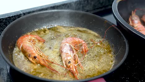Tweezers-removing-prawns-from-pan-with-boiling-oil