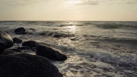 Waves-rolling-into-rocky-shore-in-afternoon-sun