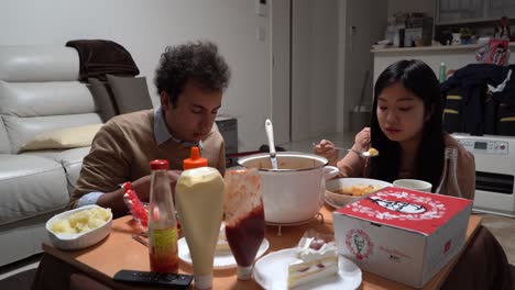 Couple-having-traditional-Japanese-Christmas-dinner-with-KFC,-home-party