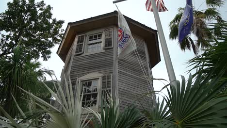 Old-Caribbean-House-With-Nautical-Flagpole-in-Front-On-a-Cloudy-Day-Pan-Up