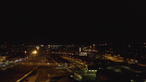 Drone-flying-over-empty-railways-depot-at-night