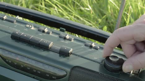 Hand-tuning-the-dial-on-FM-AM-portable-radio