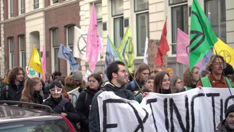Extinction-Rebellion-Protesters-Marching-in-Amsterdam-With-Protesters-Holdings-Signs-and-Flags