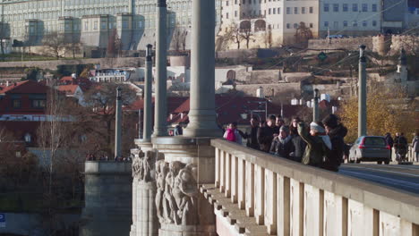 Pedestrians-stop-to-stare-out-from-bridge-in-Prague-in-winter
