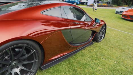 Moving-Shot-of-a-Beautiful-Red-Mclaren-at-a-Car-Show