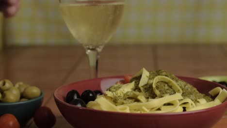 Eating-lunch-of-pasta-with-white-wine-close-up-shot
