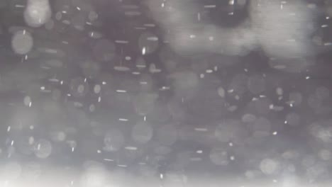 Grauer-Und-Weißer-Bokeh-abstrakter-Hintergrund-Mit-Schwebendem-Lichter-Schneeeffekt