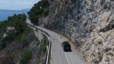 Vehicle-passing-jogger-on-narrow-mountain-road