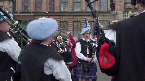 A-slow-motion-and-close-up-of-a-pipe-band-gather-in-a-circle-to-play-music-to-the-crowd